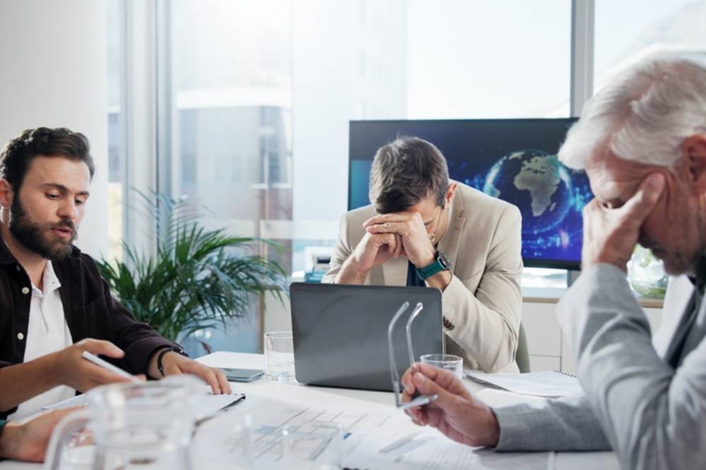 Business, finance and people with stress in meeting for stock market crash, global trade fail or bankruptcy