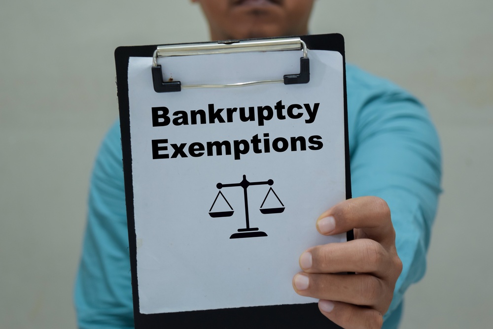 Businessman holds in hands a clipboard with the name of the bankruptcy exemptions.