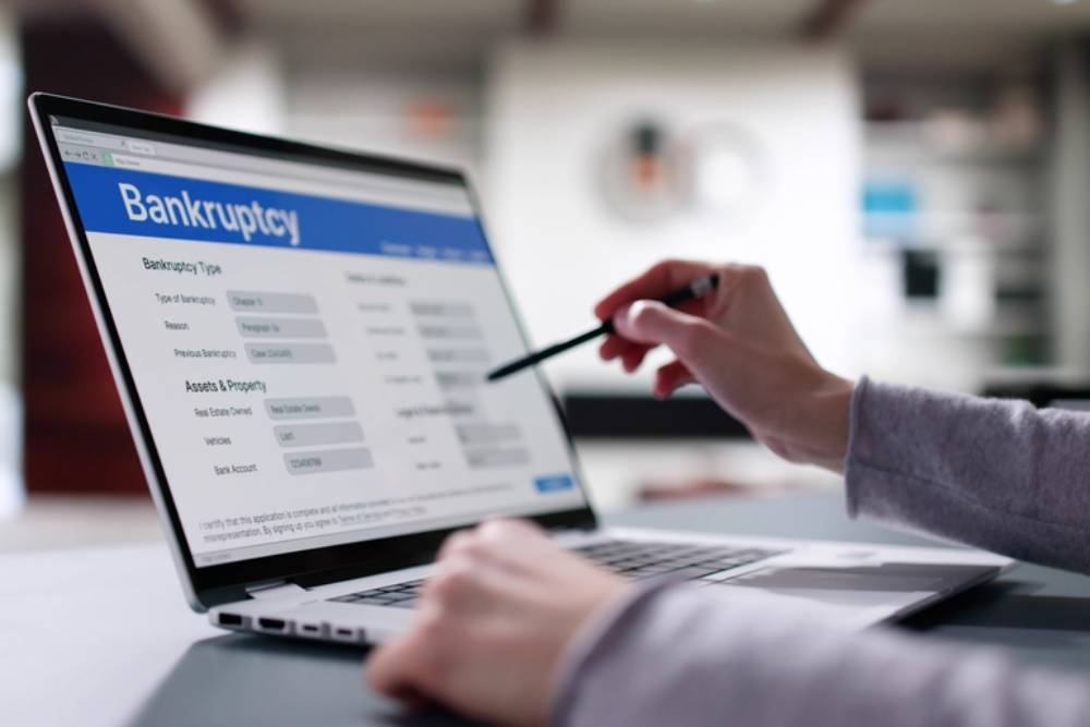 Woman Lawyer Filling Bankruptcy Form on Laptop, Insolvency Notice Online